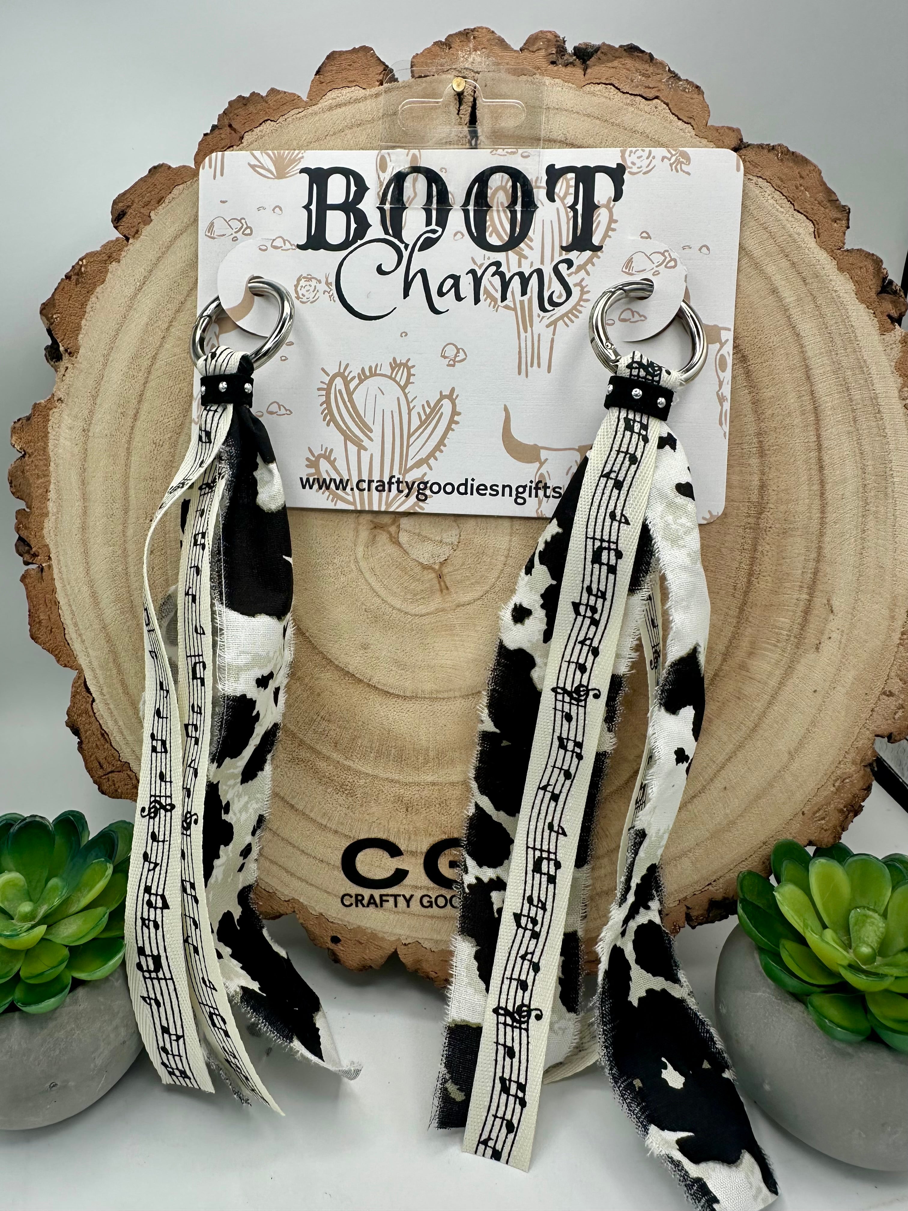 Black and white cow print and music note ribbon fringe boot charms.