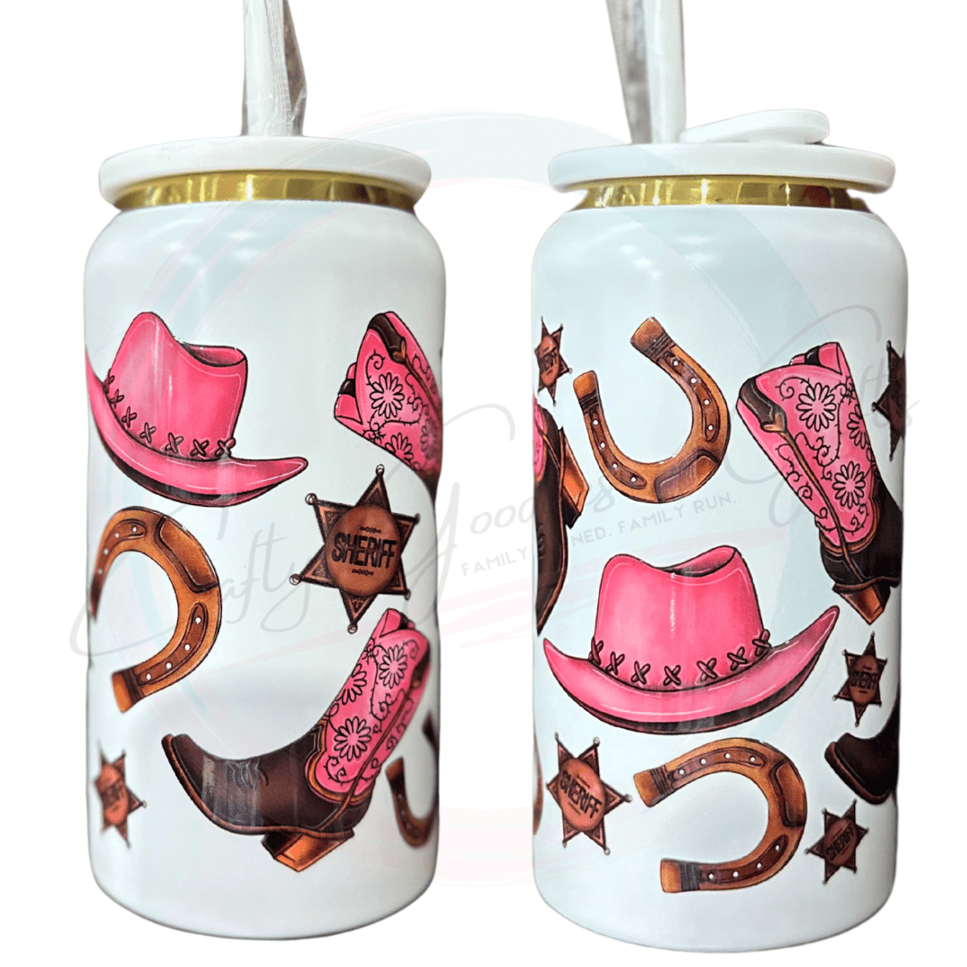 A Beautiful pink and brown design with horseshoes cowgirl hats and cowboy boots on a white 16oz tumbler. 