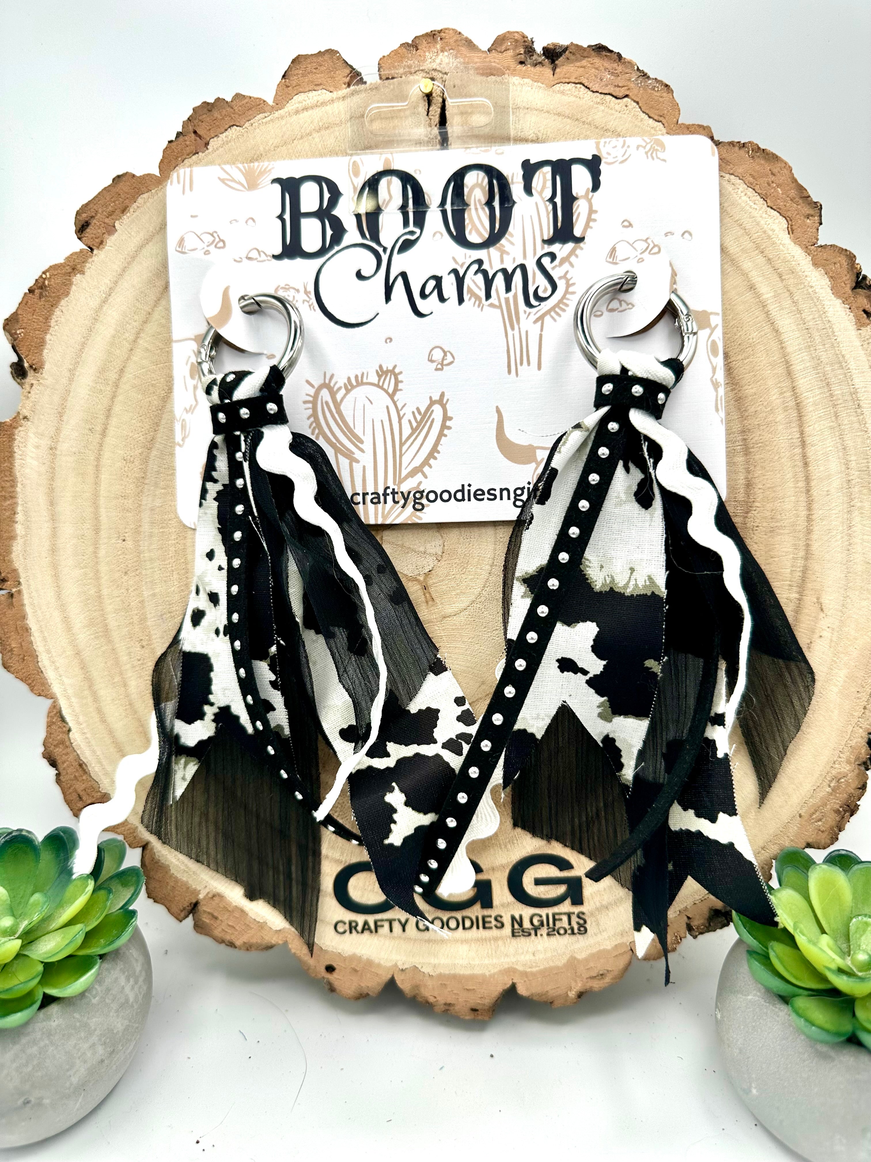 Black and white cow-print boot charms with a strip of faux bling