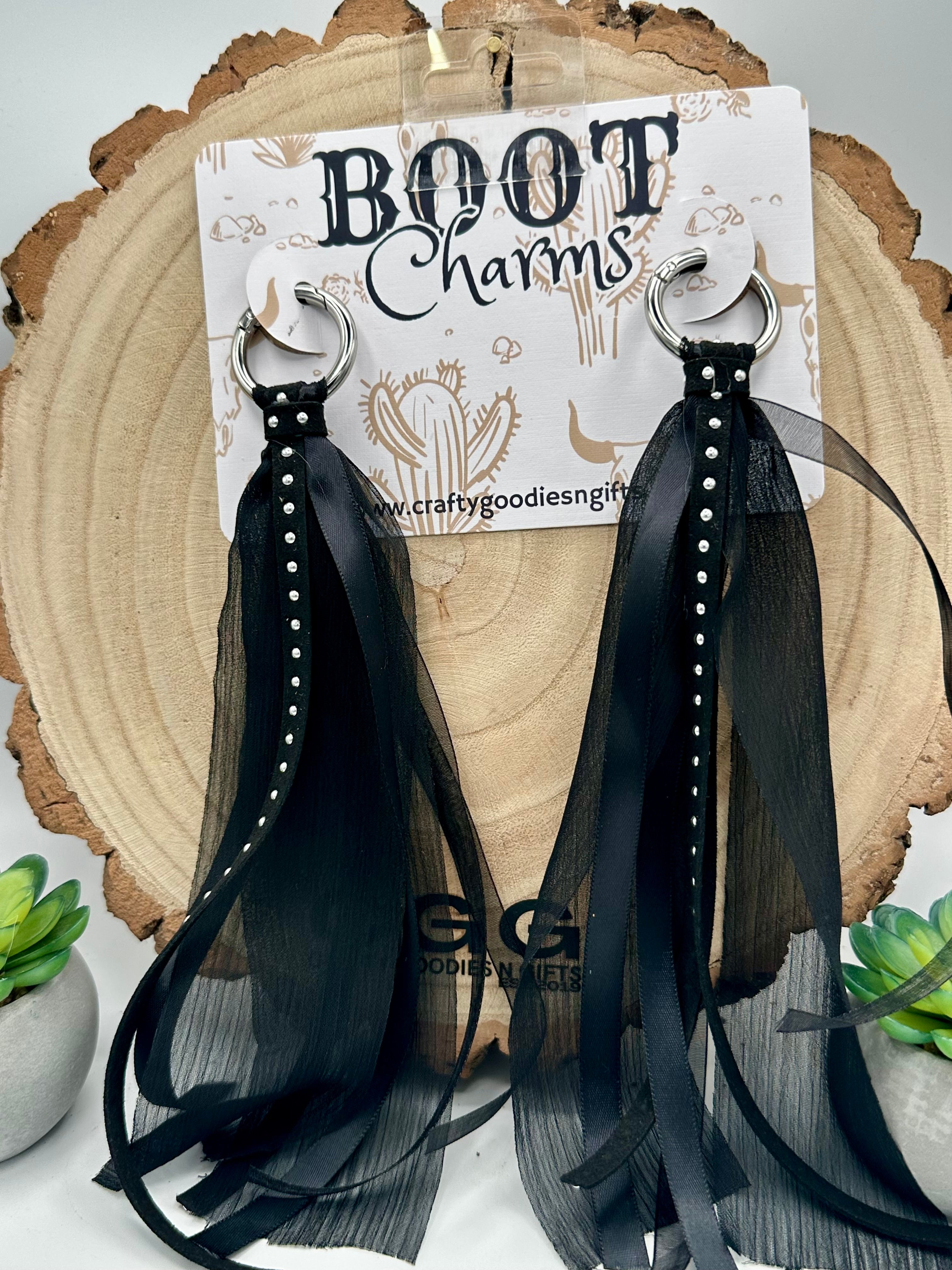 Black tassel boot charms with sheer mesh ribbons and silver-tone metal rings.