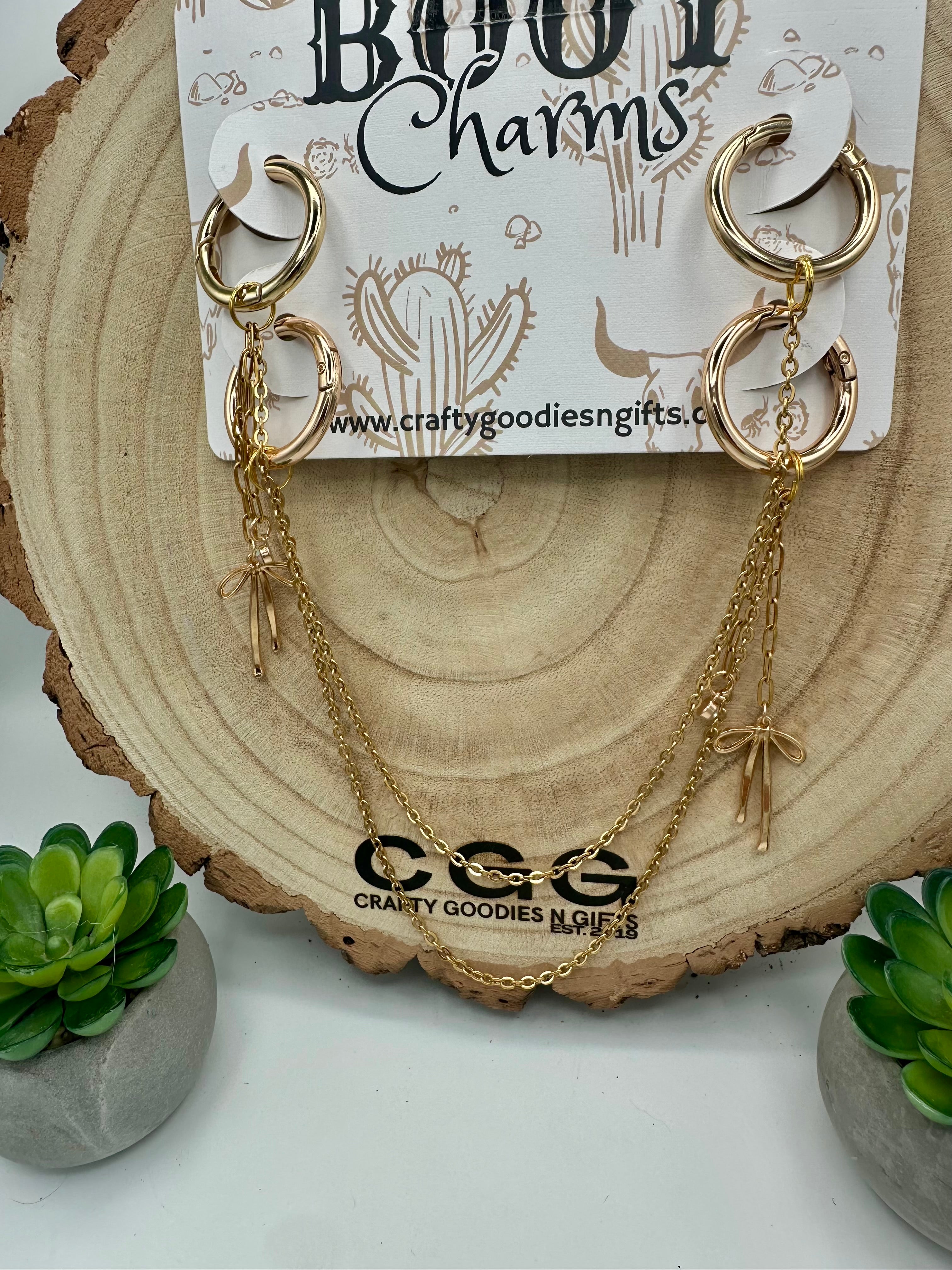 Gold hoop boot charms with layered chain dangles and small bow charms.