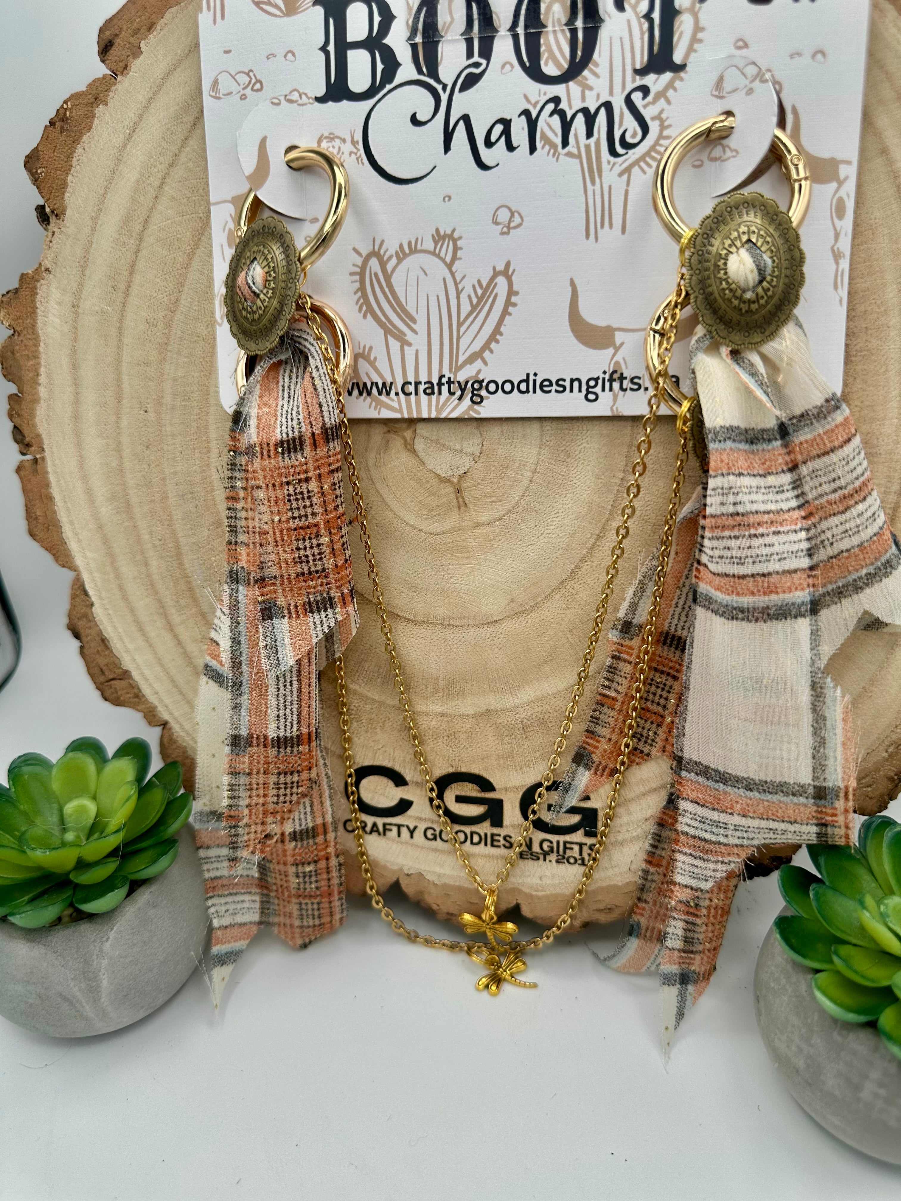 Boho-style hoop boot charms with plaid fabric tassels on a gold chain.